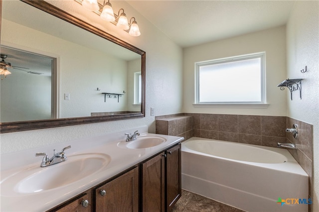 bathroom featuring vanity and a bath