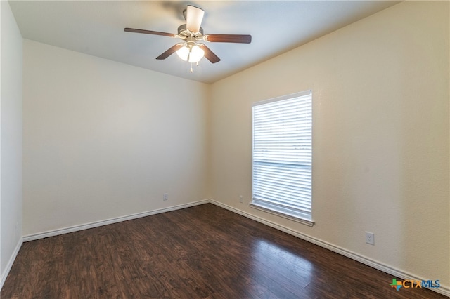 unfurnished room featuring dark wood-type flooring and ceiling fan