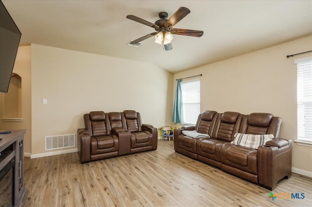 living room featuring ceiling fan and light hardwood / wood-style floors