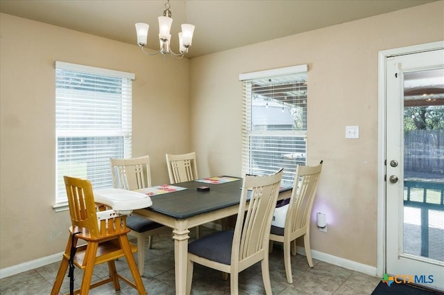 tiled dining space featuring a notable chandelier