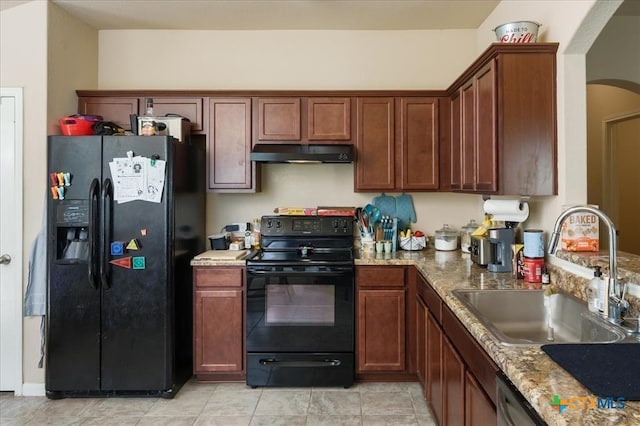 kitchen with light stone counters, sink, light tile patterned floors, and black appliances