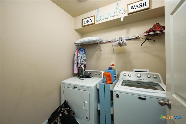 clothes washing area featuring washing machine and dryer