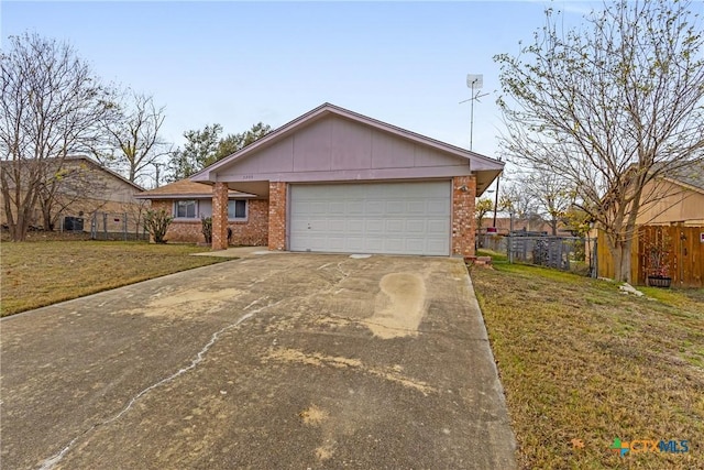 ranch-style home with a garage and a front lawn