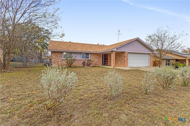 ranch-style house featuring a front lawn and a garage