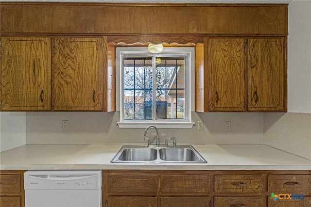 kitchen featuring white dishwasher and sink