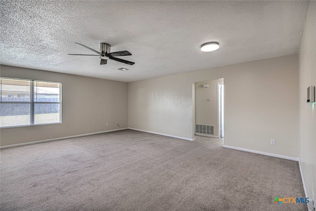 spare room featuring light colored carpet, a textured ceiling, and ceiling fan