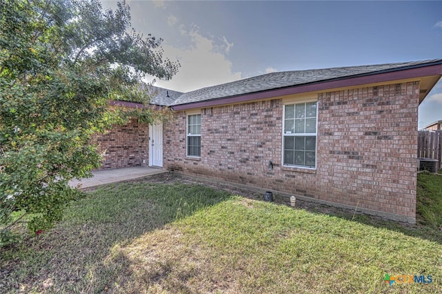 view of home's exterior with a patio and a yard