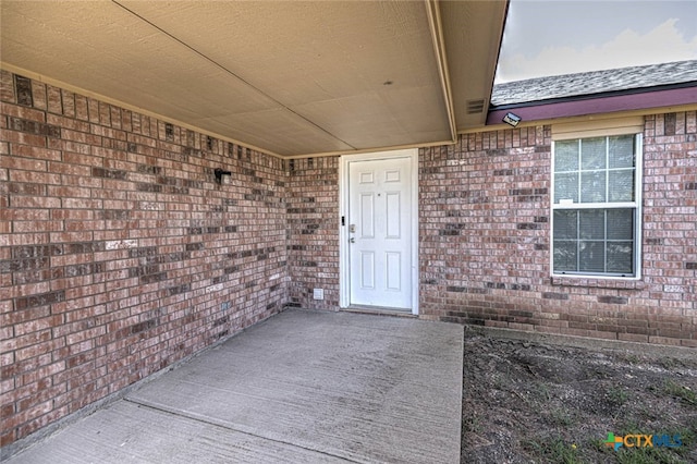 entrance to property featuring a patio area