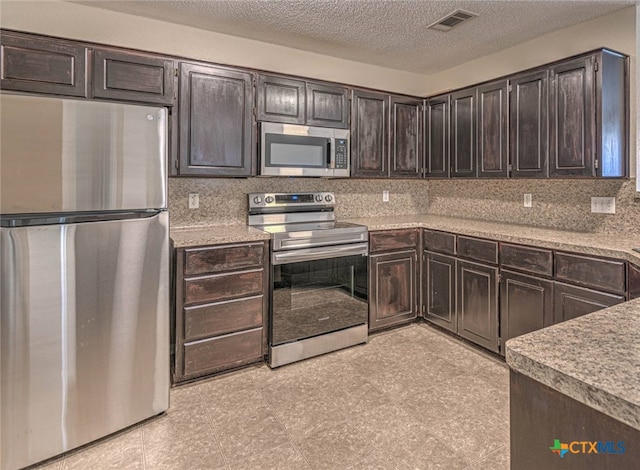 kitchen featuring backsplash, dark brown cabinets, and stainless steel appliances