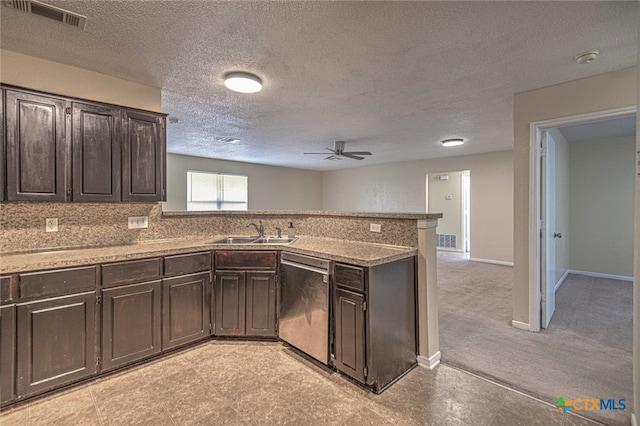 kitchen featuring a textured ceiling, stainless steel dishwasher, sink, and ceiling fan