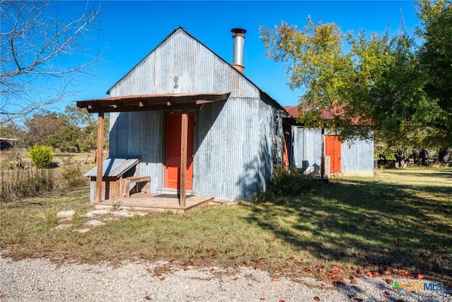 back of property featuring a lawn