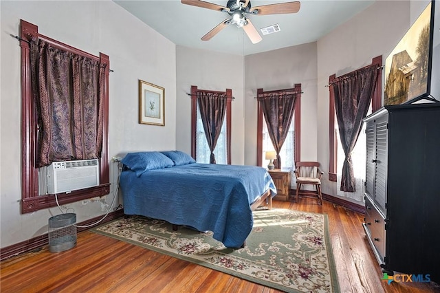 bedroom with ceiling fan and hardwood / wood-style floors