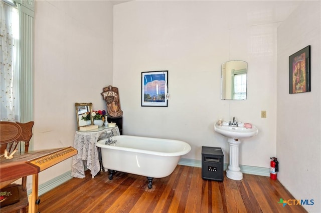 bathroom featuring a washtub and hardwood / wood-style floors