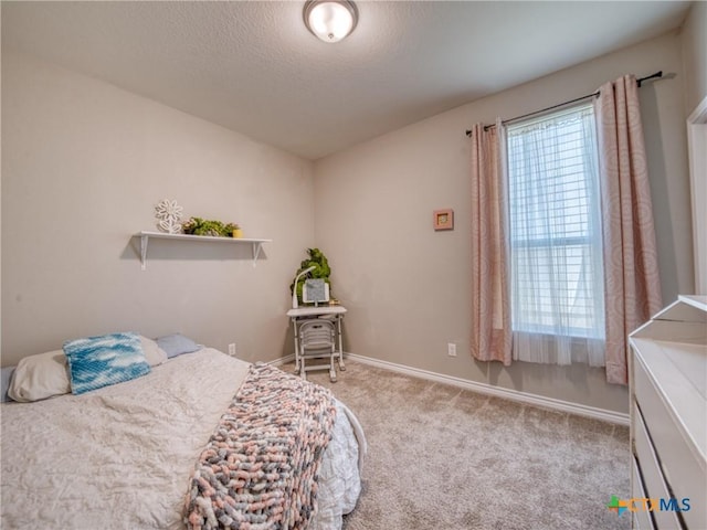 bedroom with light colored carpet and a textured ceiling