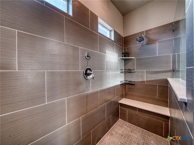 bathroom featuring a tile shower and plenty of natural light