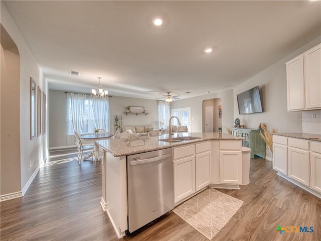 kitchen featuring white cabinetry, a kitchen island with sink, dishwasher, and sink