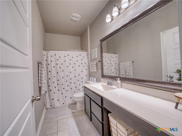 bathroom featuring a shower with curtain, tile patterned floors, toilet, and vanity