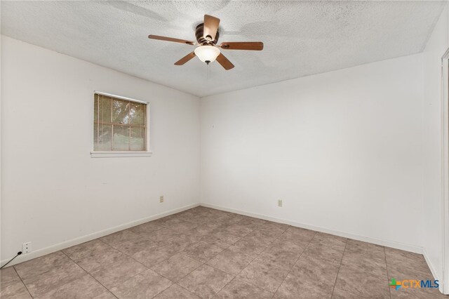 unfurnished room featuring ceiling fan and a textured ceiling