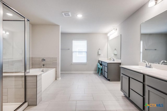 9012 Huxley Dr, Providence Village, TX 76227 - bathroom with a stall shower, a garden tub, two vanities, baseboards, and recessed lighting
