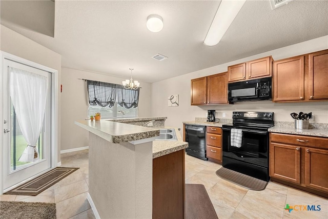 1212 Wethersfield Ln, Temple, TX 76504 - kitchen featuring black appliances, a chandelier, light countertops, brown cabinetry, and a kitchen island with sink