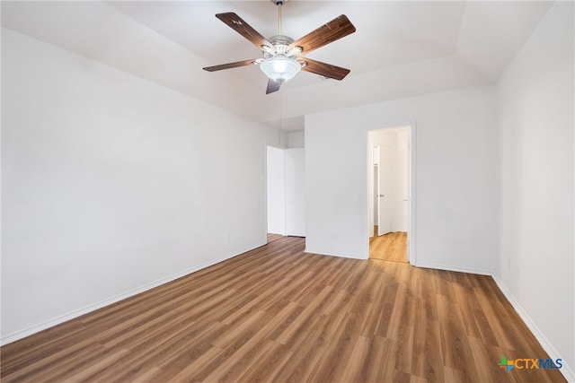 empty room with hardwood / wood-style flooring and ceiling fan