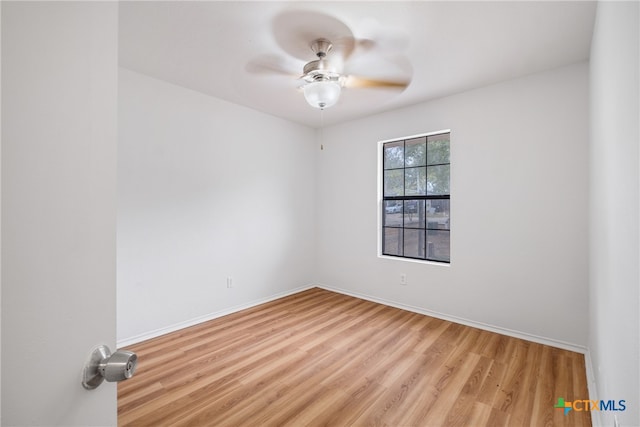 unfurnished room with ceiling fan and light wood-type flooring