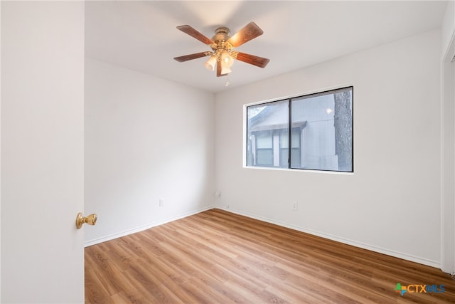 spare room featuring hardwood / wood-style floors and ceiling fan