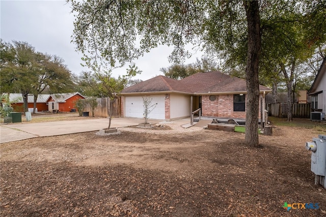 view of front of home with cooling unit and a garage