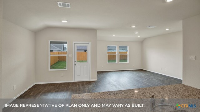 empty room featuring dark hardwood / wood-style floors and vaulted ceiling