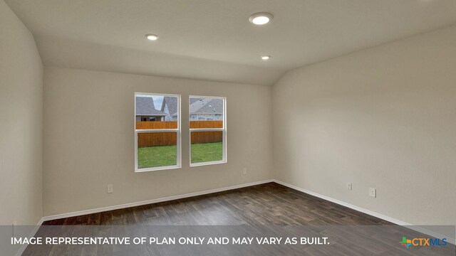 empty room featuring dark wood-type flooring and lofted ceiling