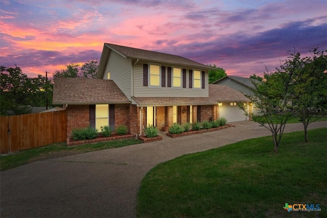 traditional-style house featuring curved driveway and brick siding