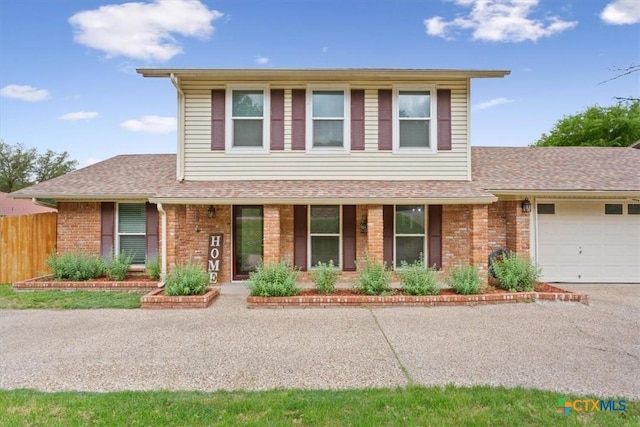 view of front of property featuring a garage, brick siding, fence, covered porch, and a shingled roof