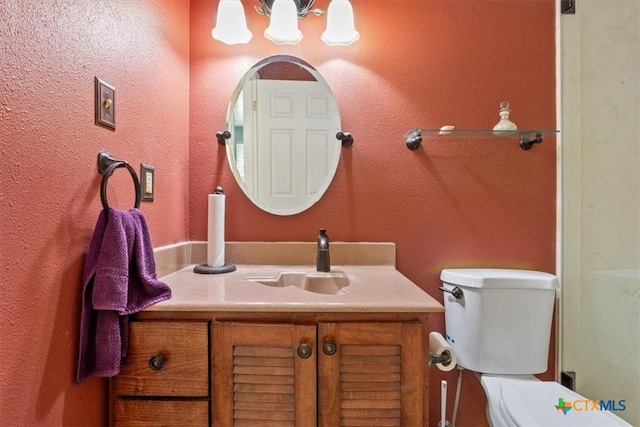 bathroom featuring toilet and vanity