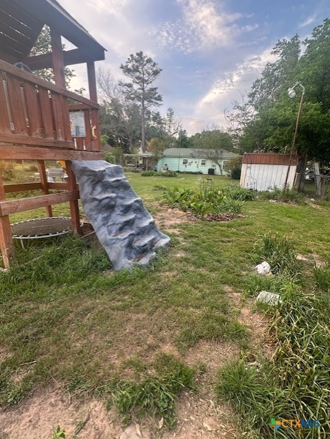 view of yard featuring a storage unit and an outbuilding