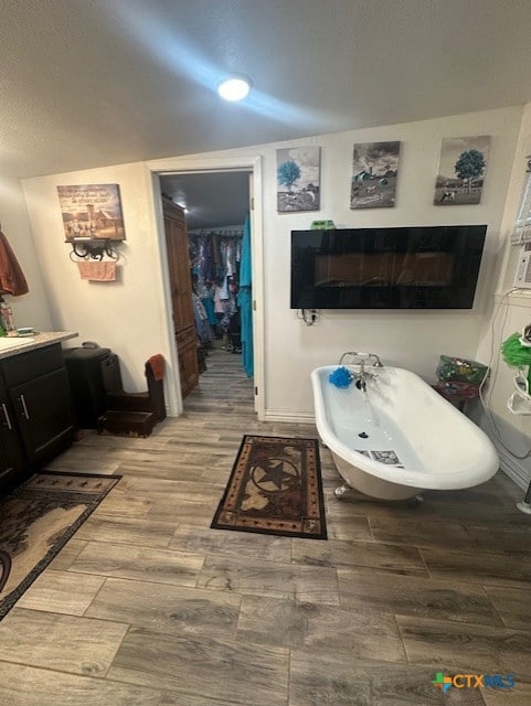 interior space featuring a freestanding bath and wood finished floors