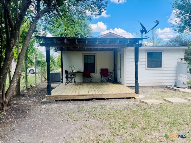 rear view of house with gas water heater and a wooden deck