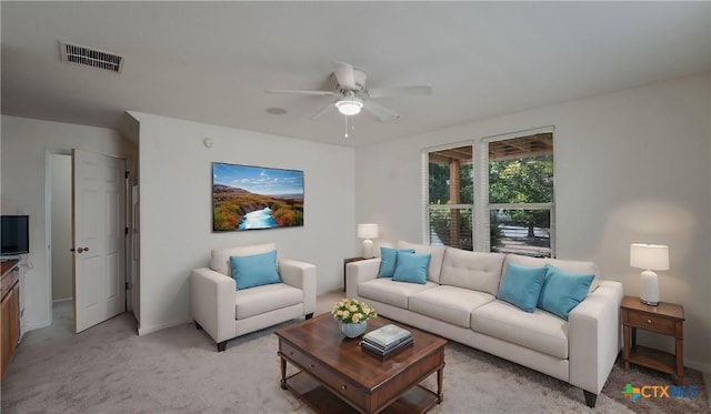 carpeted living room with ceiling fan