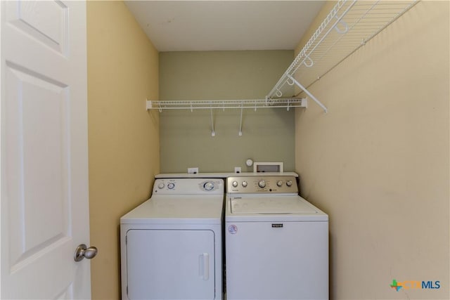 clothes washing area with washer and dryer