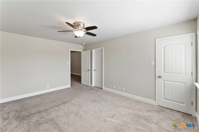 unfurnished bedroom with light carpet and ceiling fan