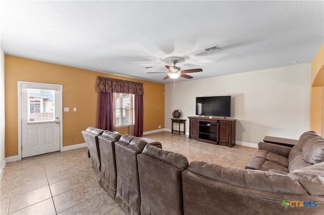 tiled living room featuring a textured ceiling and ceiling fan