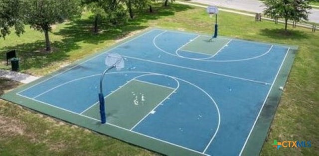 view of sport court with a yard