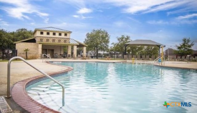 view of swimming pool featuring a patio