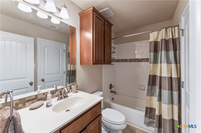 full bathroom with vanity, tile patterned floors, toilet, and shower / tub combo with curtain