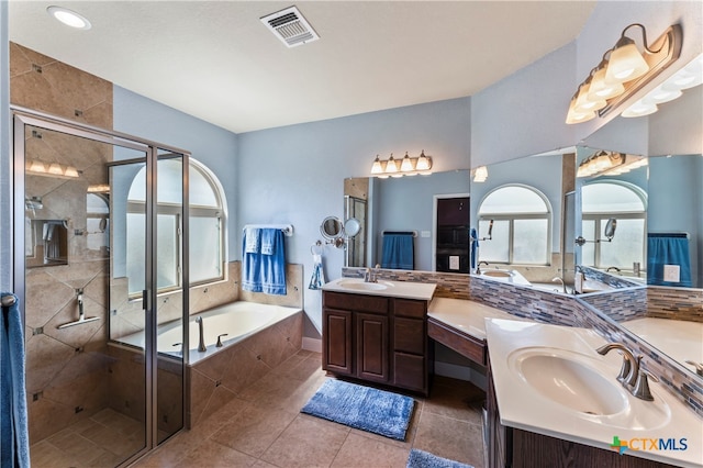 bathroom featuring vanity, tile patterned floors, and plus walk in shower