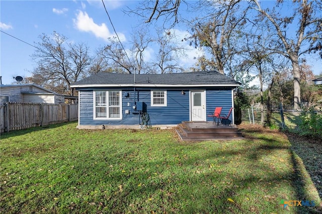 back of property featuring a lawn