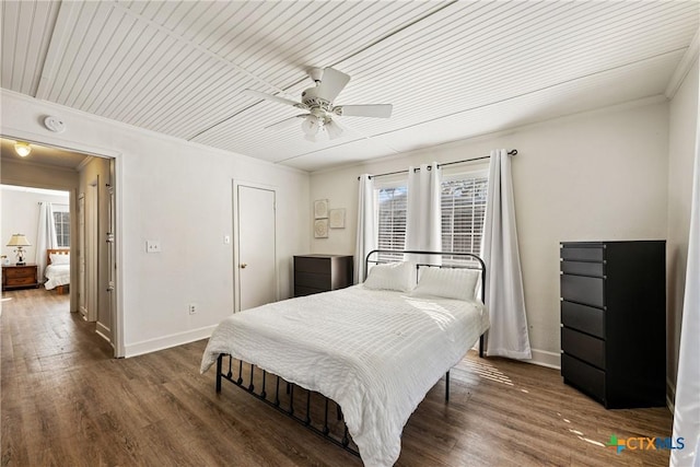 bedroom with ceiling fan, wooden ceiling, dark wood-type flooring, and ornamental molding