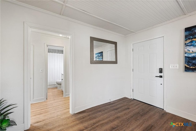 foyer entrance with hardwood / wood-style floors and ornamental molding