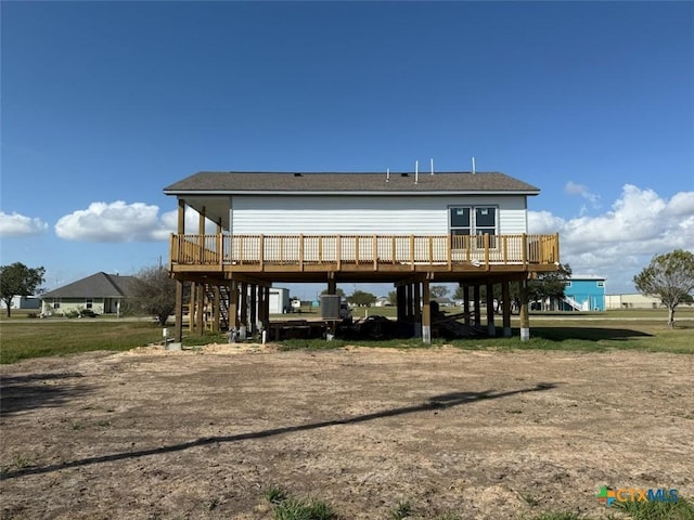 43 Buckskin Dr, Palacios, TX 77465 - back of property with a deck, a carport, stairs, and driveway