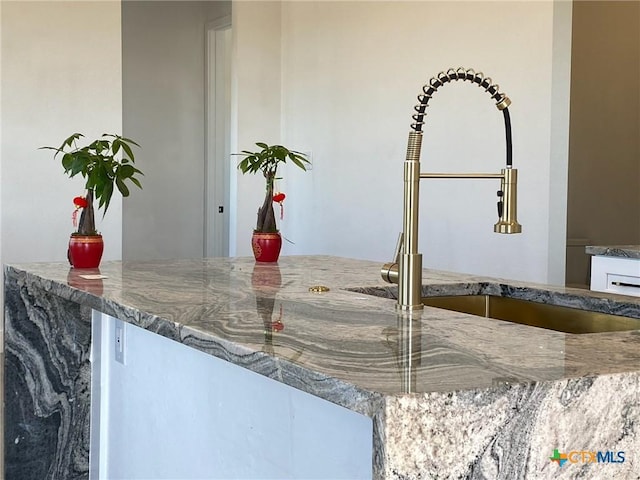 room details featuring sink and stone countertops