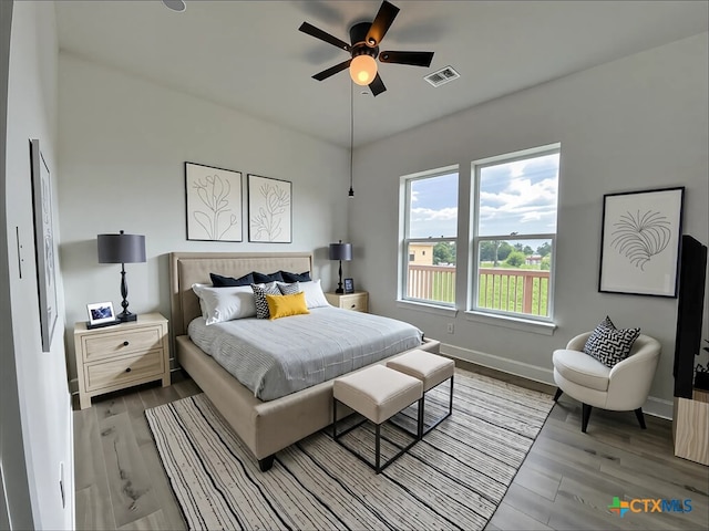 43 Buckskin Dr, Palacios, TX 77465 - bedroom with wood finished floors, visible vents, ceiling fan, and baseboards
